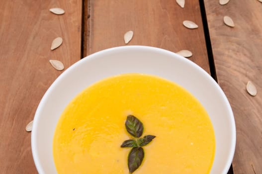 Bowl of Butternut Squash Soup on Old Wooden Table