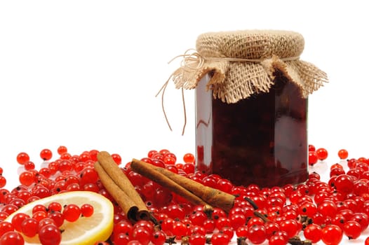 Jar of homemade red currant jam with fresh fruits