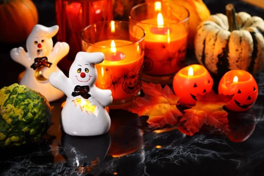 Halloween candle-light with pumpkins on black background