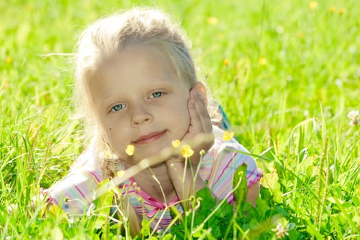 Little girl lying on grass