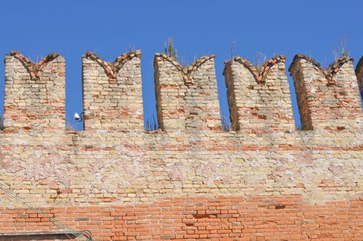 Detail of ancient Medieval castle over blue sky