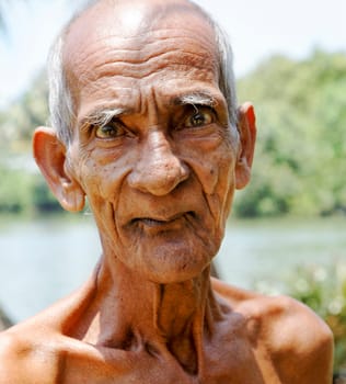 Close up portrait of old man from a Kerala waterside village