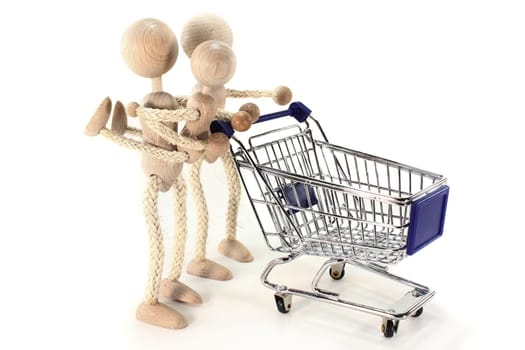 a wooden doll family with shopping cart