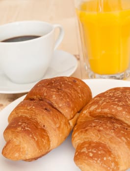 Breakfast - Croissants, Coffee and Orange Juice on Wooden Table