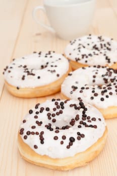 Breakfast - Donuts and White Cup on Wooden Table