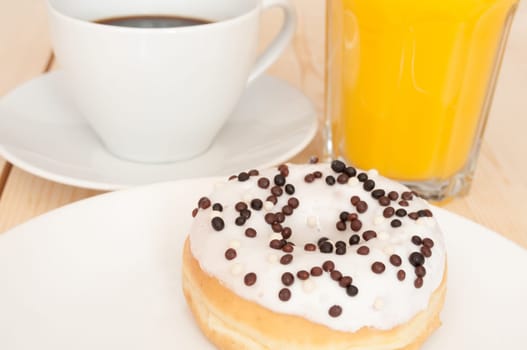 Breakfast - Donut, Coffee and Orange Juice on Wooden Table