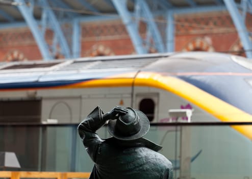 LONDON - SEPTEMBER 21: Betjeman statue in St Pancras Station on September 21, 2011. Arriving passengers from Eurostar to the new International Terminal are greeted by famous statue of John Betjeman.