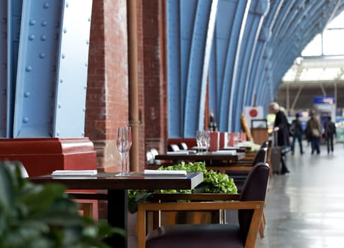Restaurant or cafe tables along the wall at english train station in London