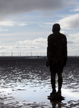 CROSBY BEACH, ENGLAND - SEPTEMBER 24: Statues forming Another Place by Antony Gormley on Crosby Beach on September 24, 2011. The statues are slowly rusting away with the tides and wind.