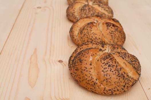 Kaiser Rolls With Poppy Seeds - Buns on Wooden Background
