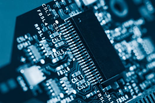 close-ups of microchips, transistors and circuitboard, dark blue toning concept