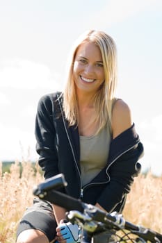 Mountain biking happy young woman relax in cornfield sunny countryside