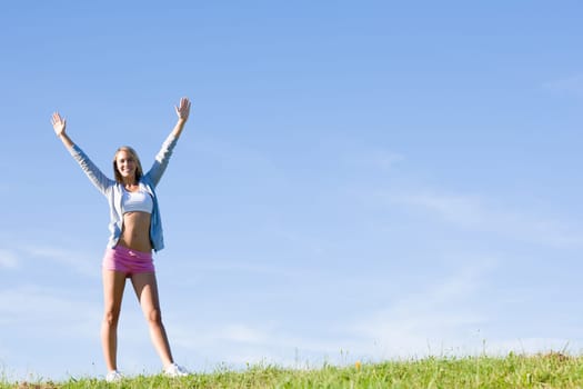 Sportive stretching young happy woman meadows blue summer sky