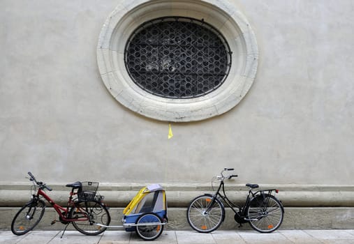 bicycles parked near a baroque facade in city center