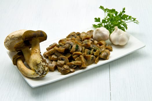 cooked and fresh mushrooms  with garlic and parsley