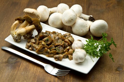 cooked and fresh mushrooms  with garlic and parsley