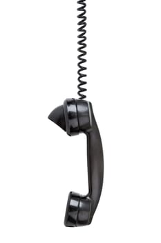 Old vintage phone with wear and tear hanging off the hook - sideview