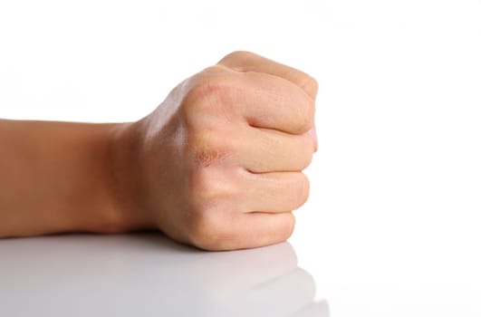 Male clenched fist isolated on white background closeup. Aggressive angry strong riot for freedom victory concept