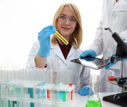 A male doctor in a chemical laboratory holds a tablet in his hand with display, you can insert a picture or an image you want to write for an advertising company