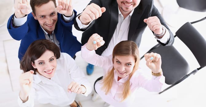 Group of joyful happy people in suits celebrate win with arms up. White collar leadership sale result feel fun good news profit bargain initiative achievement corporate life style deal concept