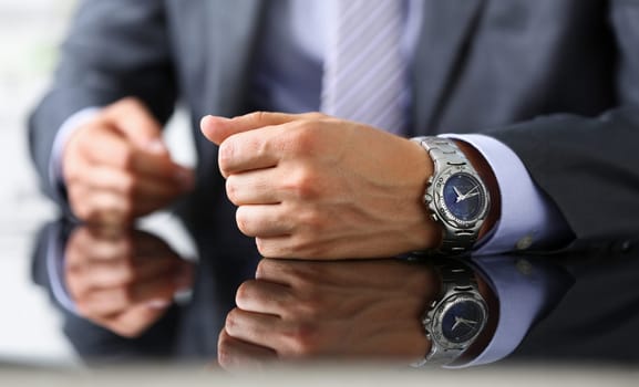 Man in suit and tie check out time at silver wristwatch closeup. Waste minute modern punctual life style start hurry job idea last second clockwork precision concept