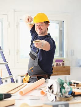 Arm of smiling worker hold brush closeup. Manual job workplace DIY inspiration improvement fix shop yellow helmet hard hat joinery startup idea industrial education profession career concept