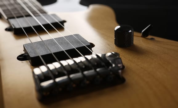 Classic shape wooden electric guitar with rosewood neck closeup. Six stringed learning lesson musician school education art leisure electrical vintage stage wood guitar concept