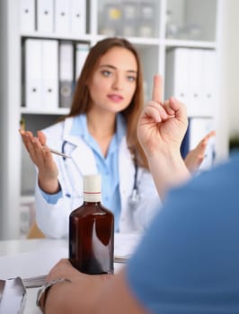 Alcoholic hold in arm empty bottle showing fuck off with middle finger to doctor at reception closeup. Grief and despair of intoxicated for sober life change bad habit lifestyle dependence