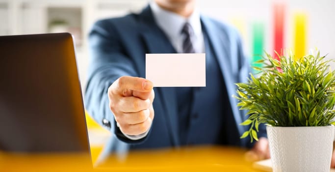 Male arm in suit give blank calling card to visitor closeup. White collar colleagues company name exchange job interview sale clerk id executive or ceo finance support formal identity concept