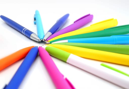 Multicolored ball point pens isolated on white background