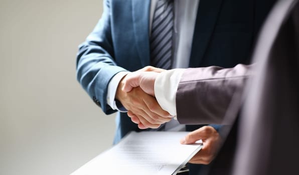 Man in suit shake hand as hello in office closeup. Friend welcome mediation offer positive introduction greet or thanks gesture summit participate approval background strike arm bargain concept