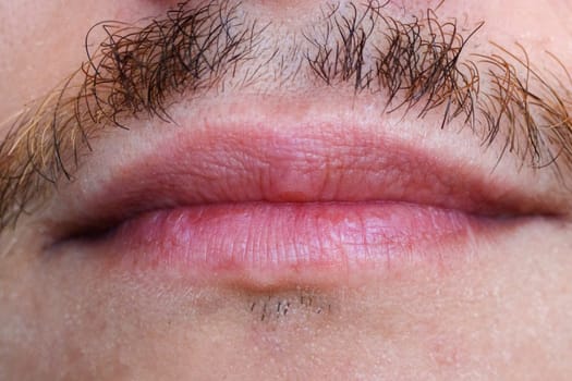 Mouth lips of a man with a mustache close-up macro. Selective focus