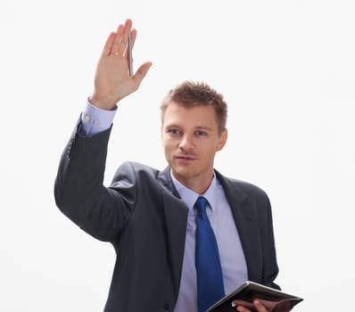 A businessman holds a hand up with a pen at a seminar asks him to give a floor to speak. Out to make a comment to talk with a lecturer a note on a statement.