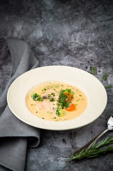 fish soup with green onions, carrots and broccoli