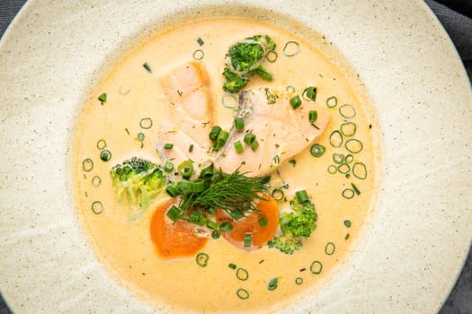 fish soup with green onions, carrots and broccoli