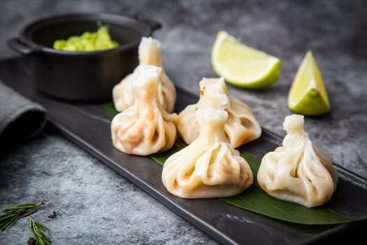 juicy khinkali with sauce on the black background