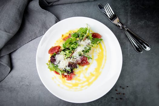 salad with red cabbage, meat, cheese and herbs with sauce