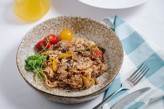 udon noodles with duck meat, herbs, sesame seeds and cherry tomatoes