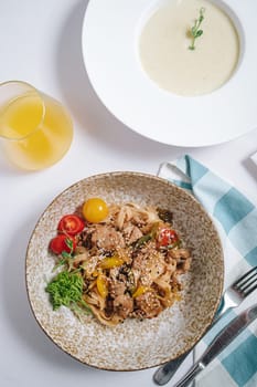 udon noodles with duck meat, herbs, sesame seeds and cherry tomatoes