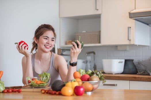 Sporty young woman is preparing healthy food on light kitchen. healthy food concept..