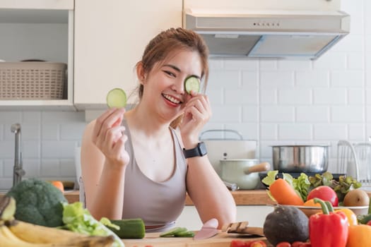 Sporty young woman is preparing healthy food on light kitchen. healthy food concept..