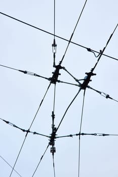 Image of Wires for city transportation clean electric energy upward abstract view with overcast sky