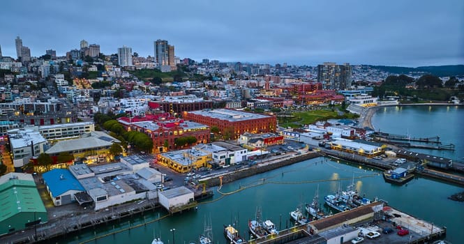 Image of Aerial city lights in San Francisco at dusk near Hyde St Pier and Fishermans Wharf on coast