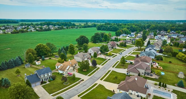 Image of Aerial rural neighborhood with farmland between neighborhoods