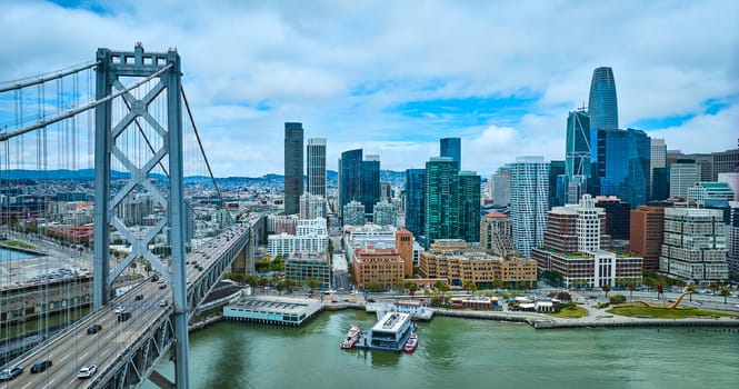 Image of Aerial Oakland Bay Bridge with view of city skyscrapers and San Francisco Fire Department Pier