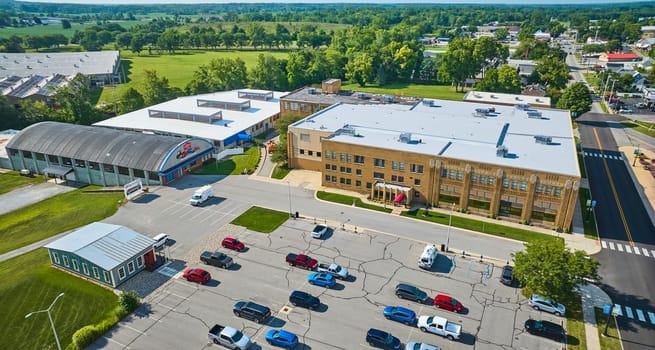 Image of Side entrance view of ACD Automobile Museum with parking lot on bright sunny day aerial