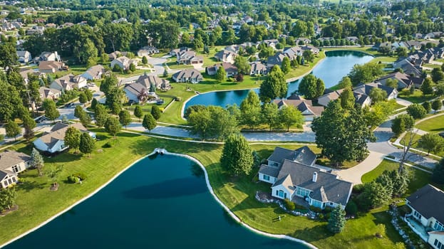 Image of Large neighborhoods with two ponds and multiple houses aerial