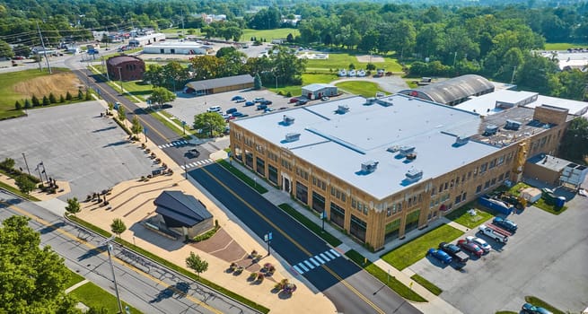 Image of Aerial over ACD Automobile Museum entrance with parking lots on bright sunny day