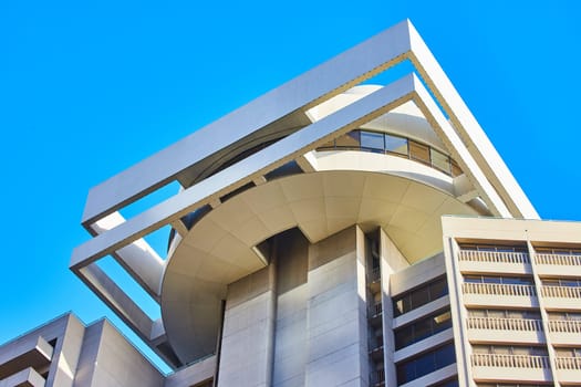 Image of Unique circular roof of building upward view with clear blue sky behind it