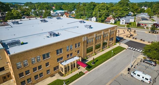 Image of Side entrance of ACD Automobile Museum with parking lot on bright sunny day aerial